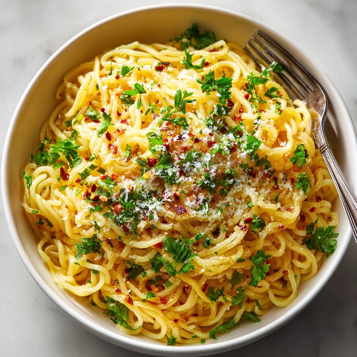 Easy, comforting Garlic Butter Pasta Ramen Hack recipe shown sizzling in skillet, fragrant garlic.