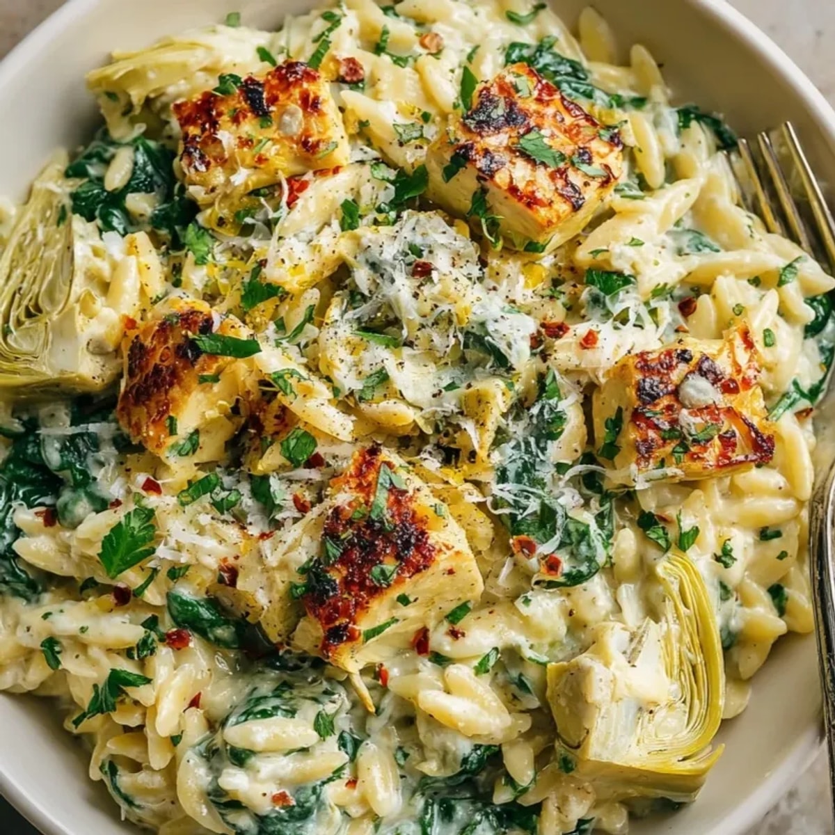 Creamy Spinach Artichoke Orzo: a warm bowl with tender pasta and cheesy sauce.