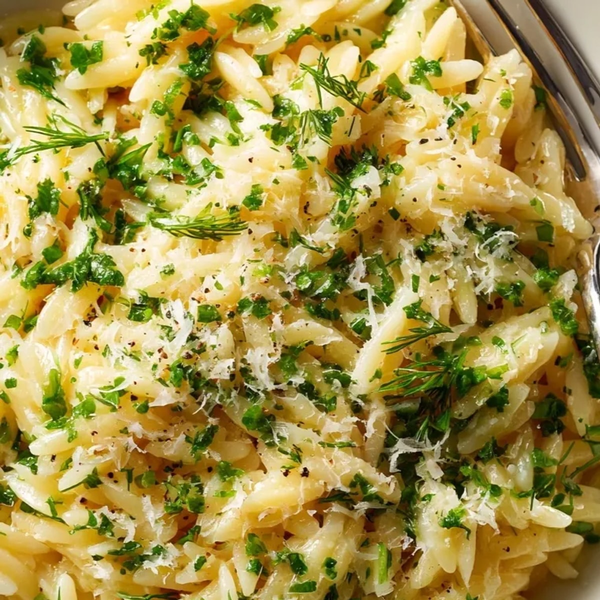 Close-up of Herb Butter Orzo: Al dente pasta glistening with melted butter and herbs.