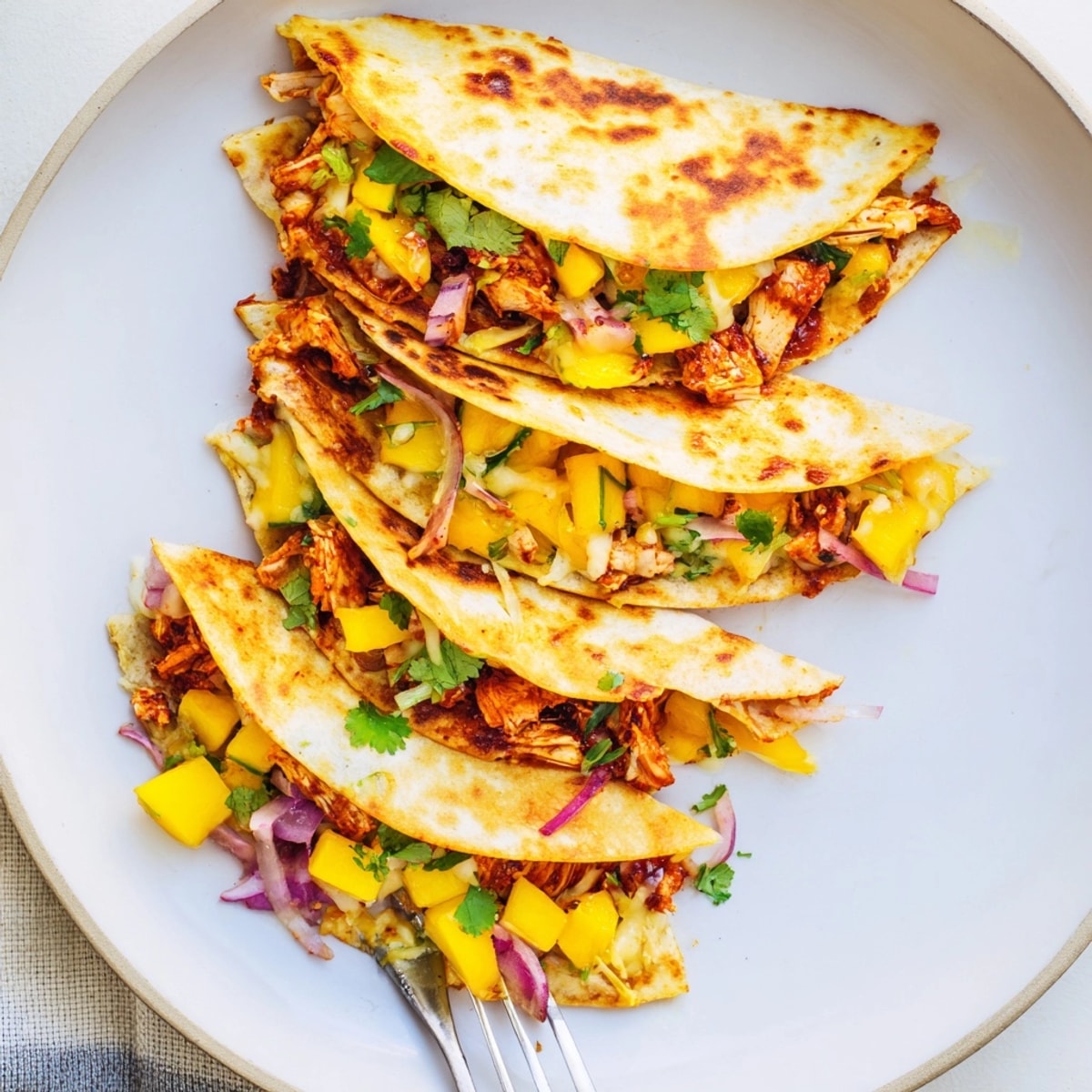 Golden mango chipotle chicken quesadillas: Warm tortillas filled with savory chicken and fresh mango.