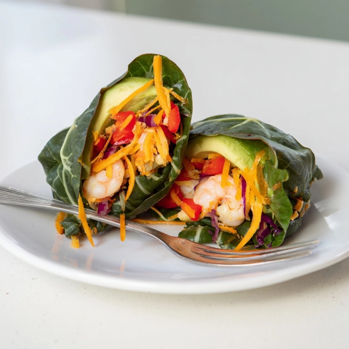 Easy recipe for low-carb lunch: Shrimp &amp; Cheddar Collard Green Wraps, sliced in half.