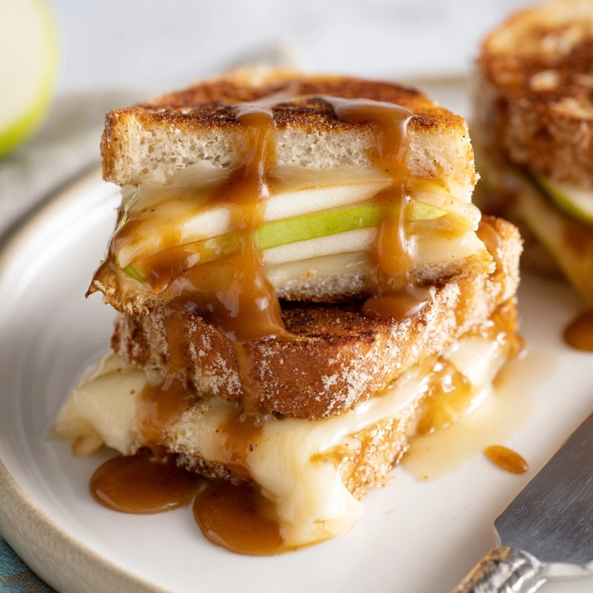 Golden, buttery Caramel Apple Mini Grilled Cheese Bites, piled high with savory cheddar.