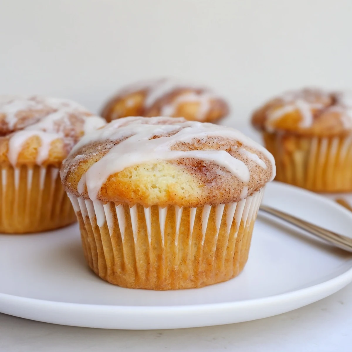 Tender cinnamon swirl ricotta cupcakes topped with a sweet glaze for dessert lovers.  