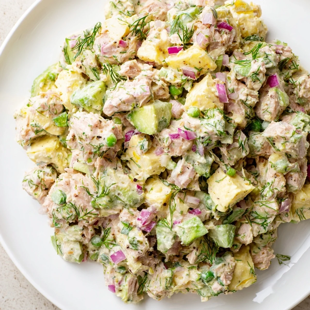 Creamy avocado ranch tuna egg salad served on whole grain toast slices.  