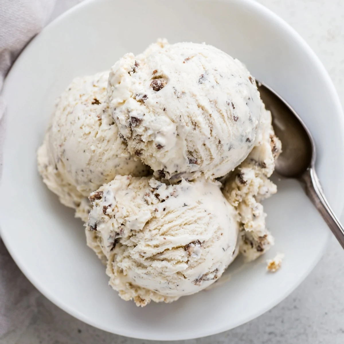 Creamy cottage cheese ice cream topped with edible cookie dough balls for indulgent delight.  