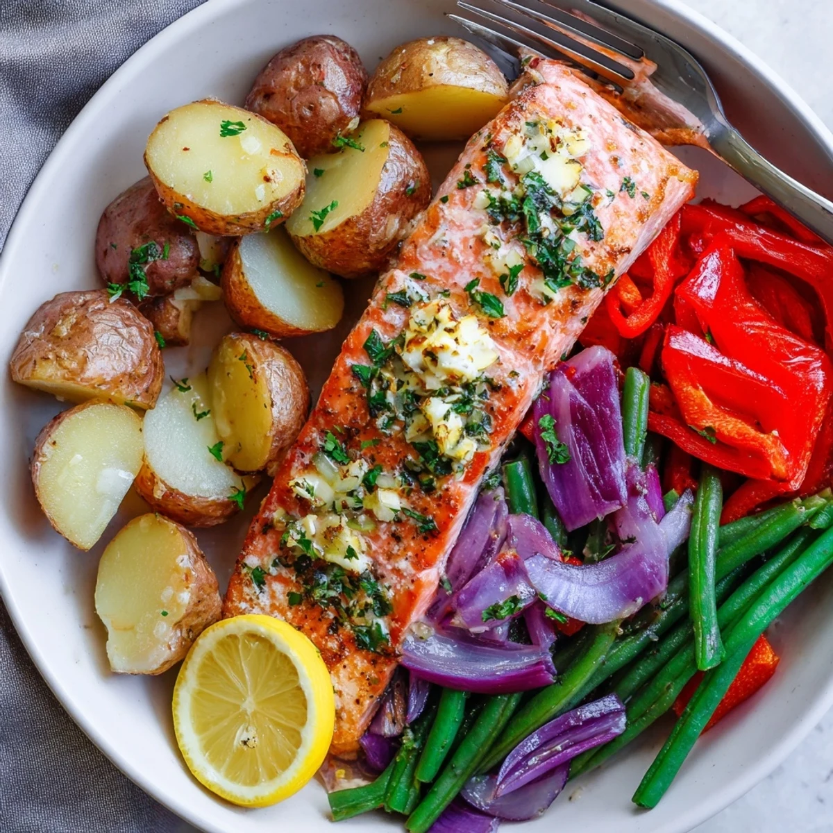 Crispy roasted potatoes and tender Lemon Herb Salmon on a sheet pan dinner.  