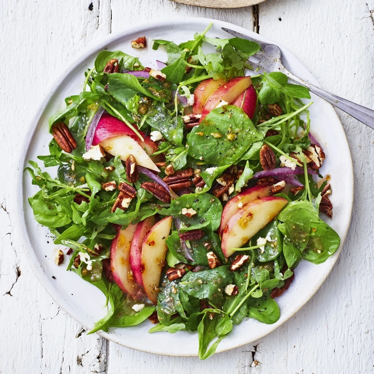 Refreshing Apple Cider Vinaigrette Salad topped with warm, fragrant roasted nuts.