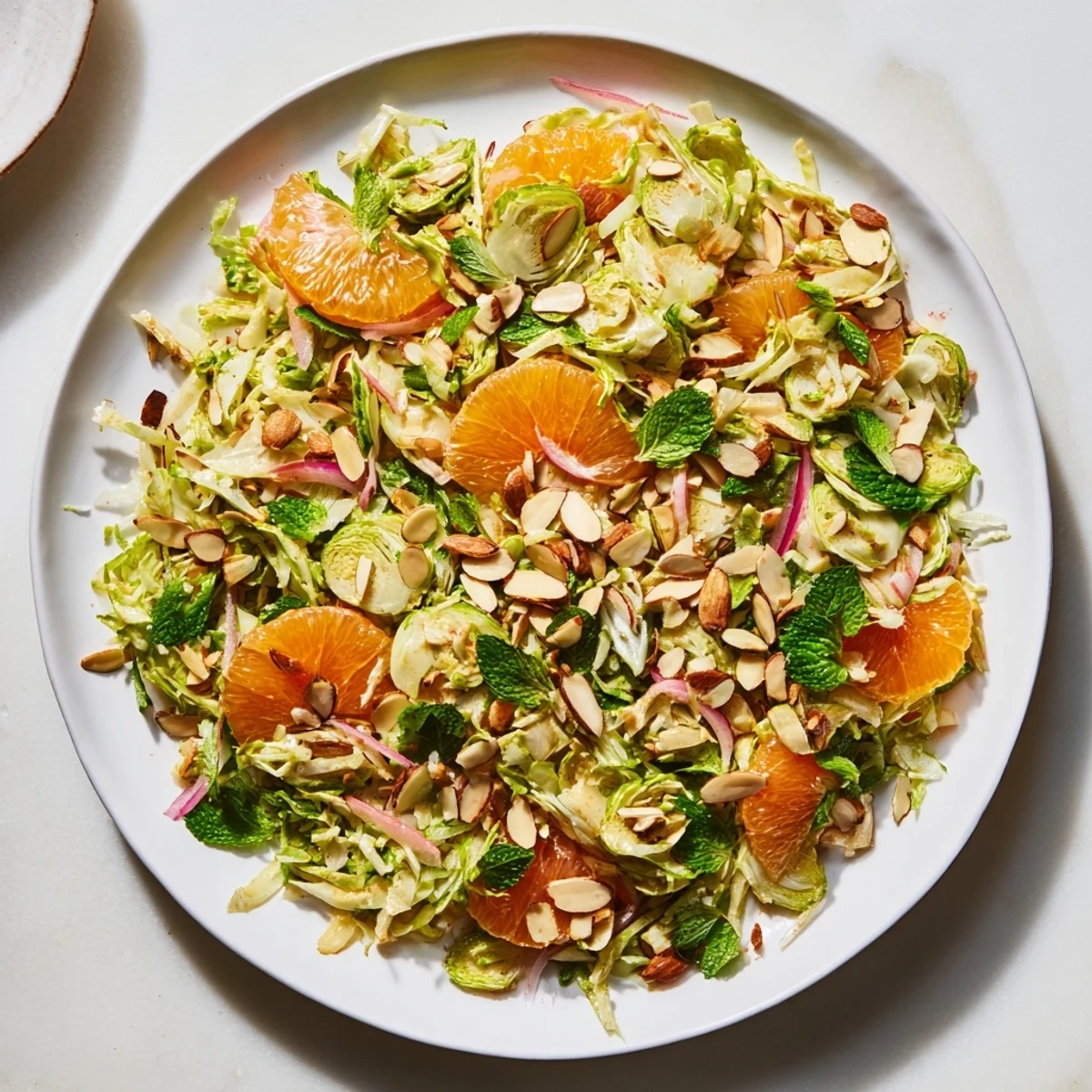 Freshly made Sparkling Citrus Brussels Sprouts Slaw, a refreshing vegetarian side bursting with bright flavors.