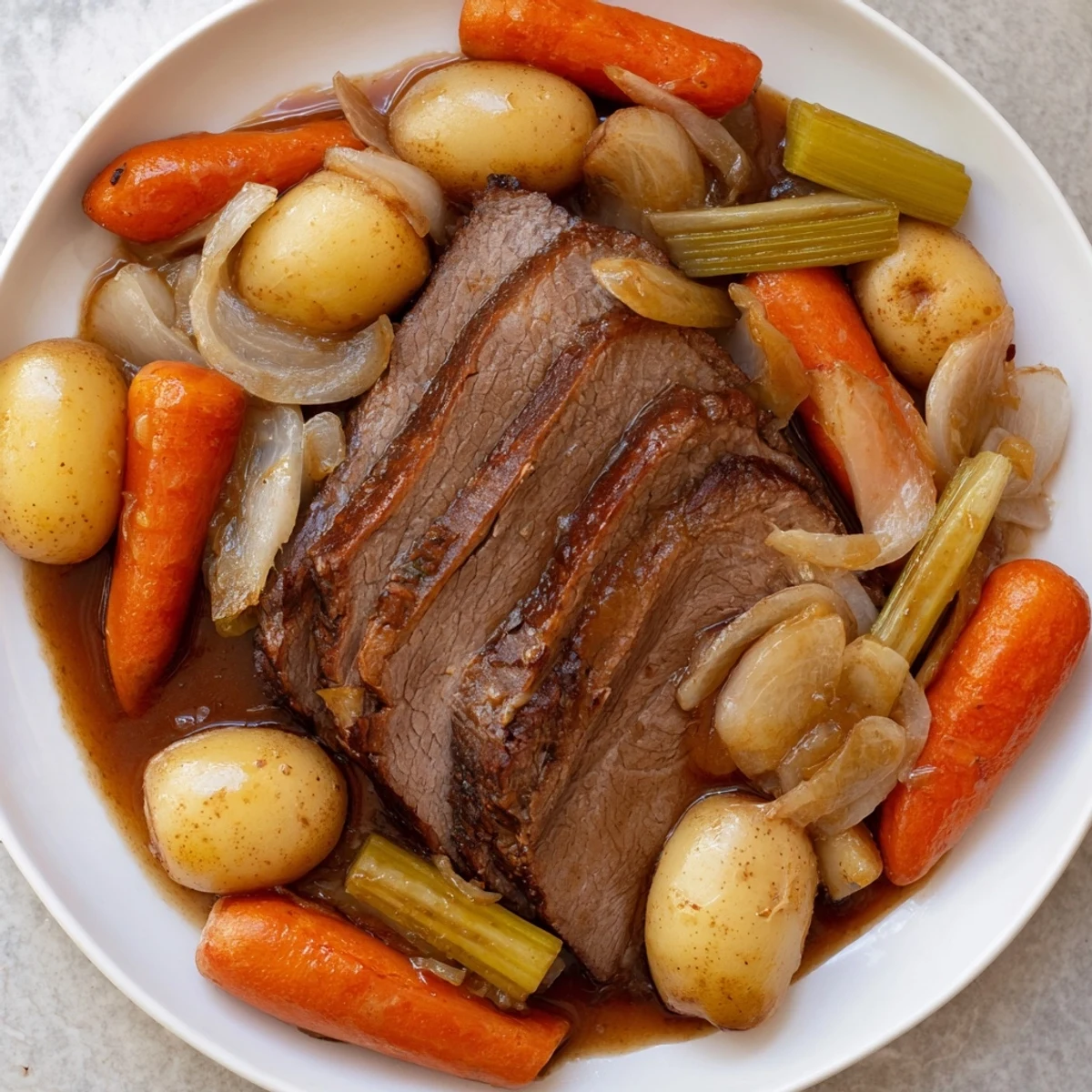 Fork-tender Pickle Brine Pot Roast, glistening with rich juices, is served with tender vegetables.
