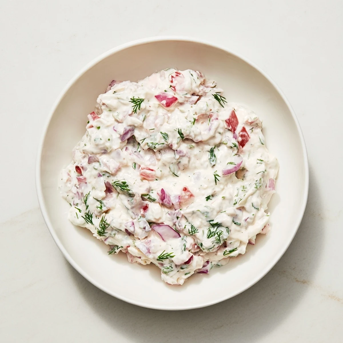 Creamy Sweet and Sour Pickle Relish Dip served in a bowl, perfect for dipping tortilla chips.