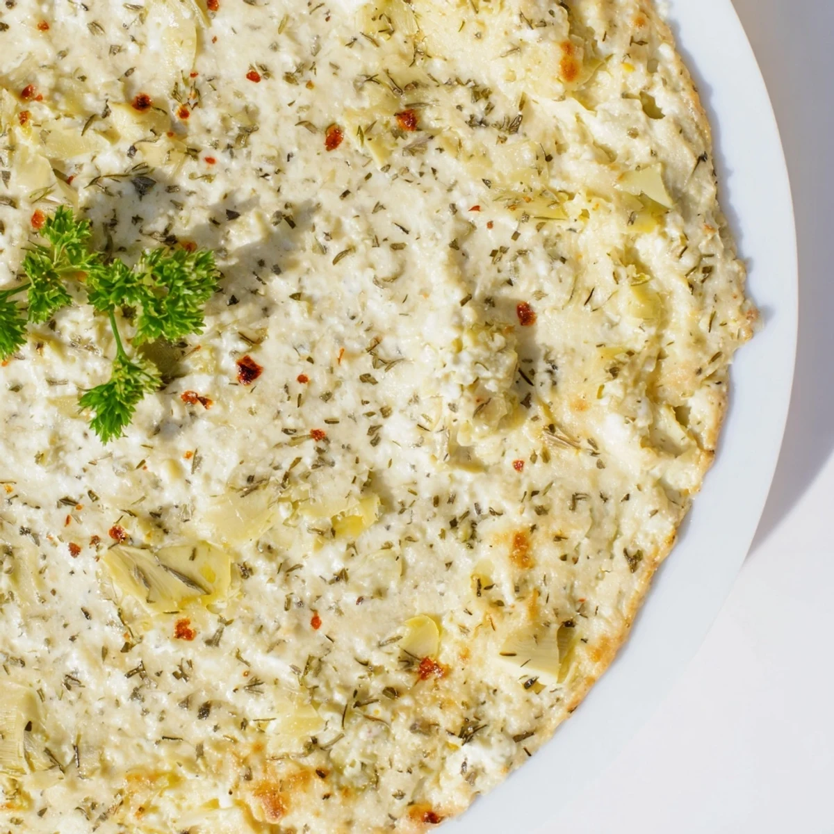 A close-up shot of hot Baked Artichoke Dip, perfect appetizer with crusty bread and crackers.