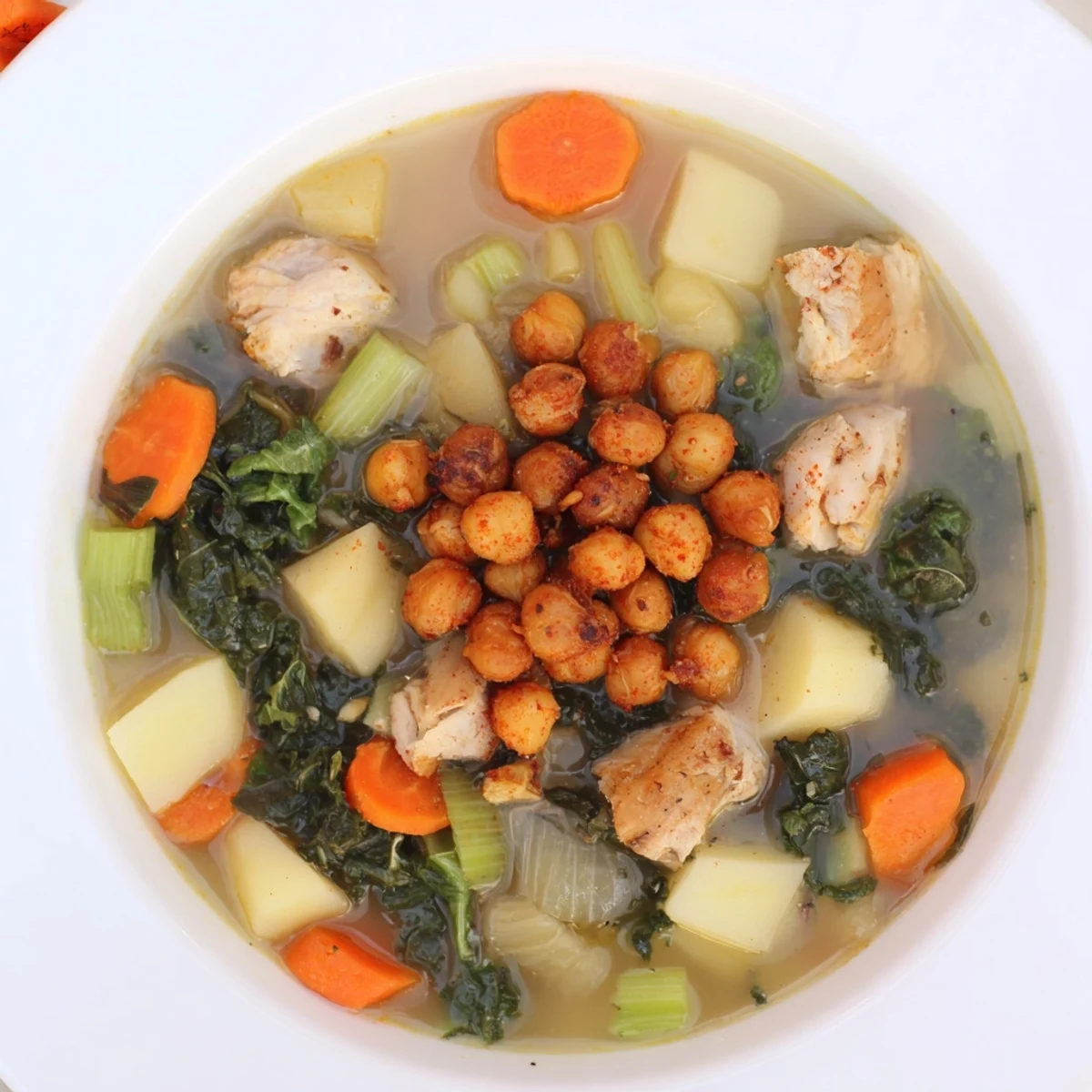 Golden, roasted chickpeas topping a bowl of Chicken Kale Soup, ready for a satisfying, healthy meal.