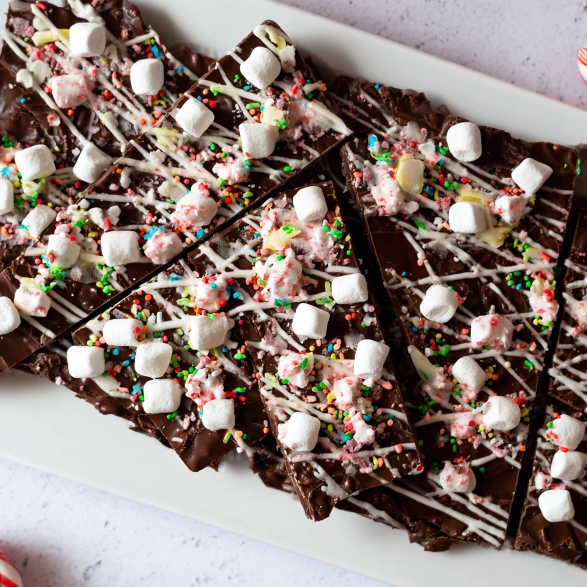 Homemade Hot Chocolate Bomb Bark, visually appealing with drizzles of white chocolate and marshmallows.