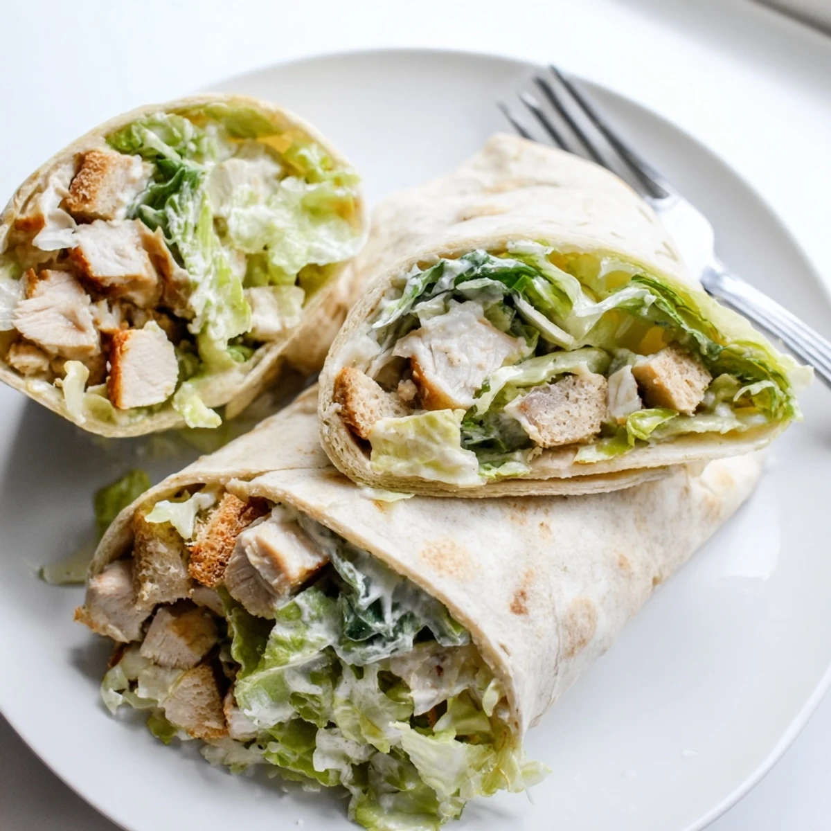 Juicy chicken Caesar wraps filled with fresh romaine and creamy dressing, perfect for lunch.