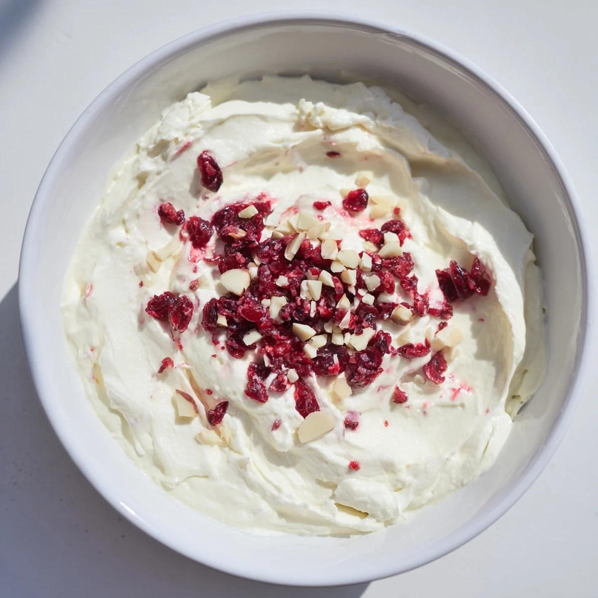 Enjoy the smooth texture of lightened holiday cream cheese dip, served with crackers, a perfect snack.