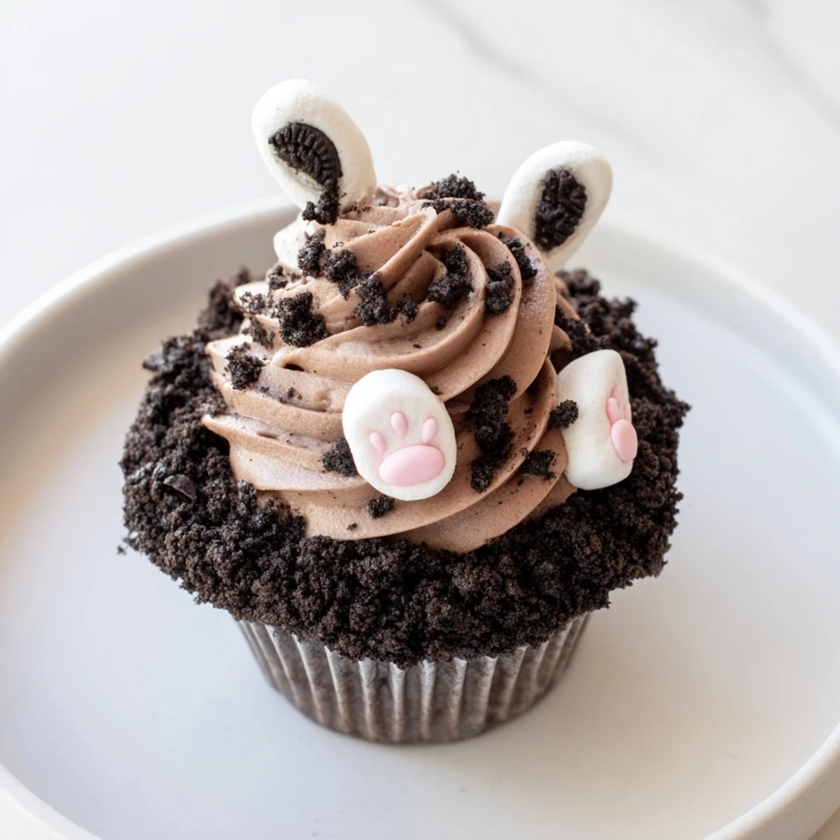 Bunny Burrow Cupcake Tray: A close-up of springtime cupcakes, chocolate buttercream "burrow" and fondant bunny feet.
