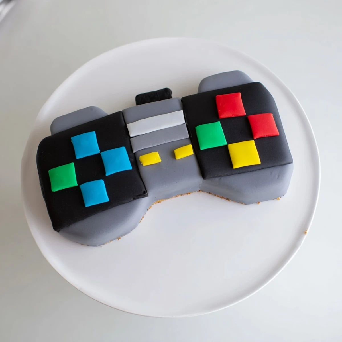 Enjoy this vanilla pixel video game controller cake; its geometric fondant details are super fun.