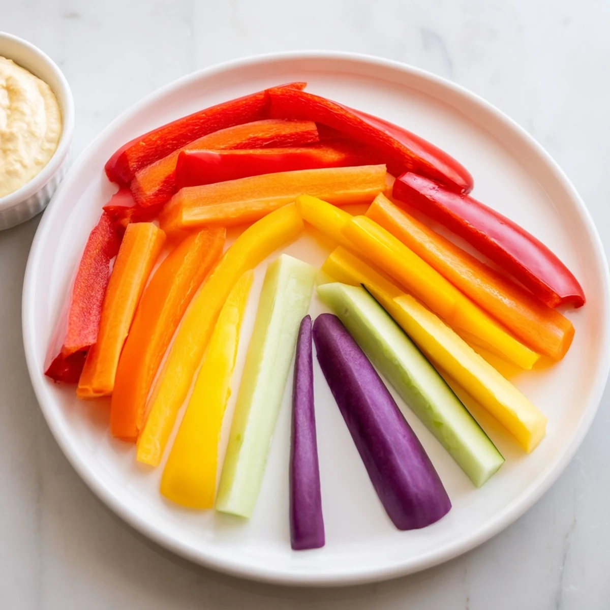 Rainbow Arch Veggie Sticks arranged in a colorful arc, perfect for a healthy and vibrant snack plate.