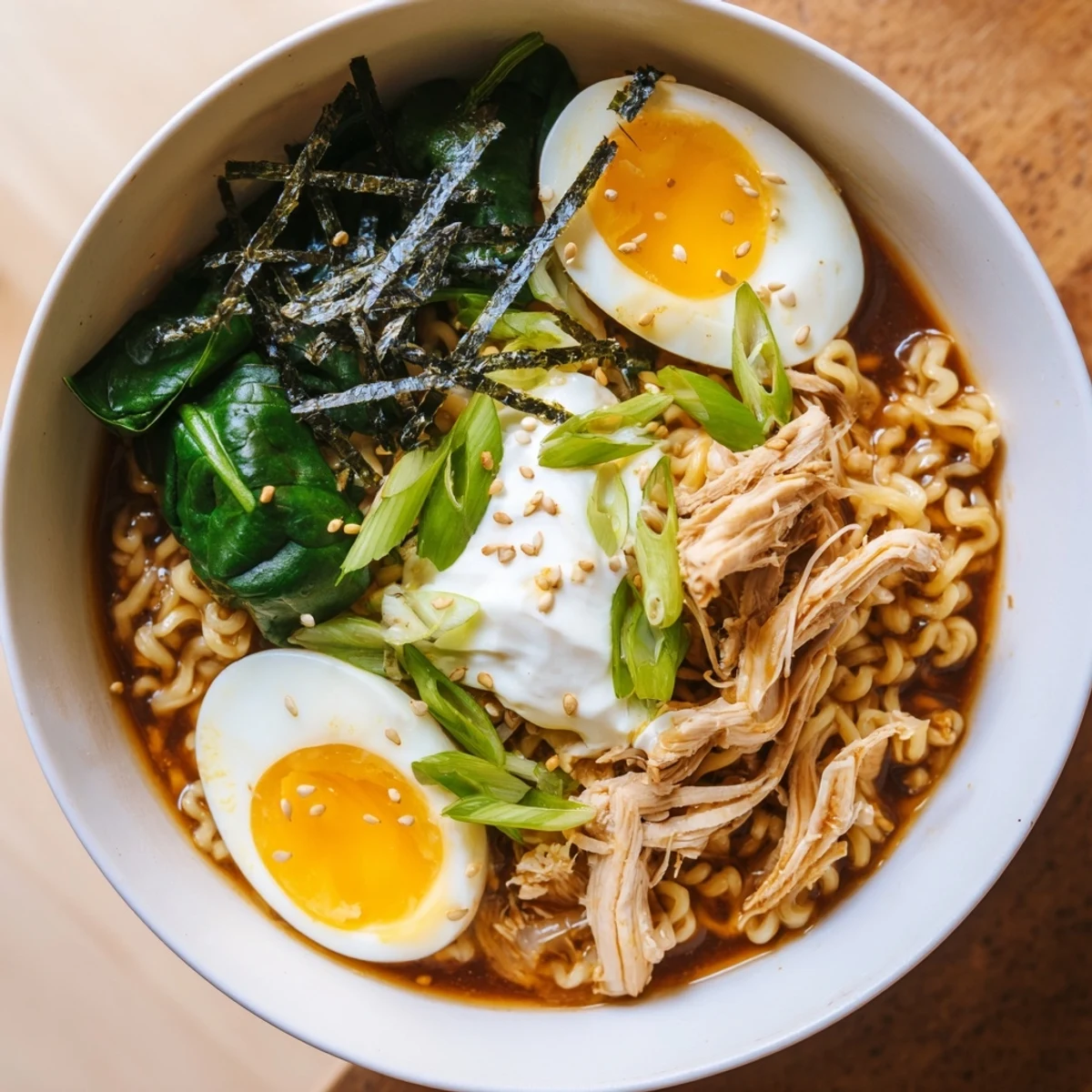 Steaming bowl of Chicken Ramen with Kewpie Mayo, topped with soft egg and scallions, ready to enjoy.
