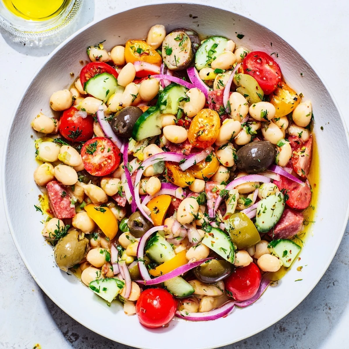 Mediterranean Dense Bean Salad with salami, a vibrant mix of beans, salami, and fresh vegetables, ready to eat.