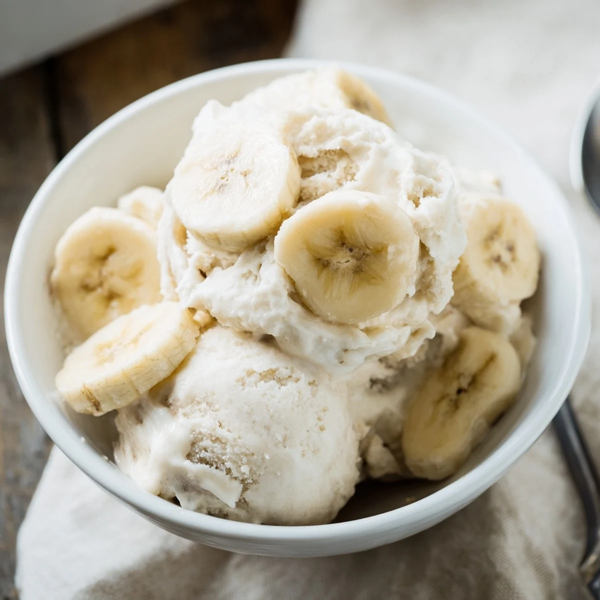 Smooth 2-Ingredient Banana Ice Cream, a vegan-friendly treat perfect for a hot afternoon, with simple ingredients.