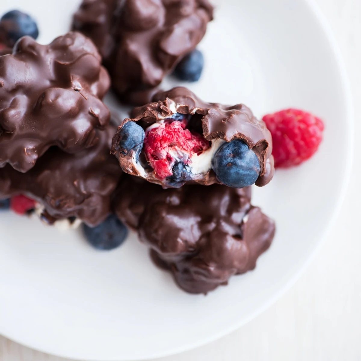 Melted chocolate enrobes each frozen Chocolate Yogurt Cluster, a perfect summer snack, ready to eat.