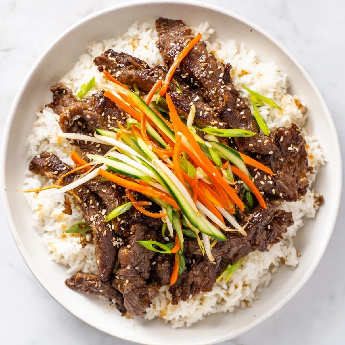 Savory bulgogi beef bowl with glistening marinated beef, vibrant vegetables, and fluffy rice.