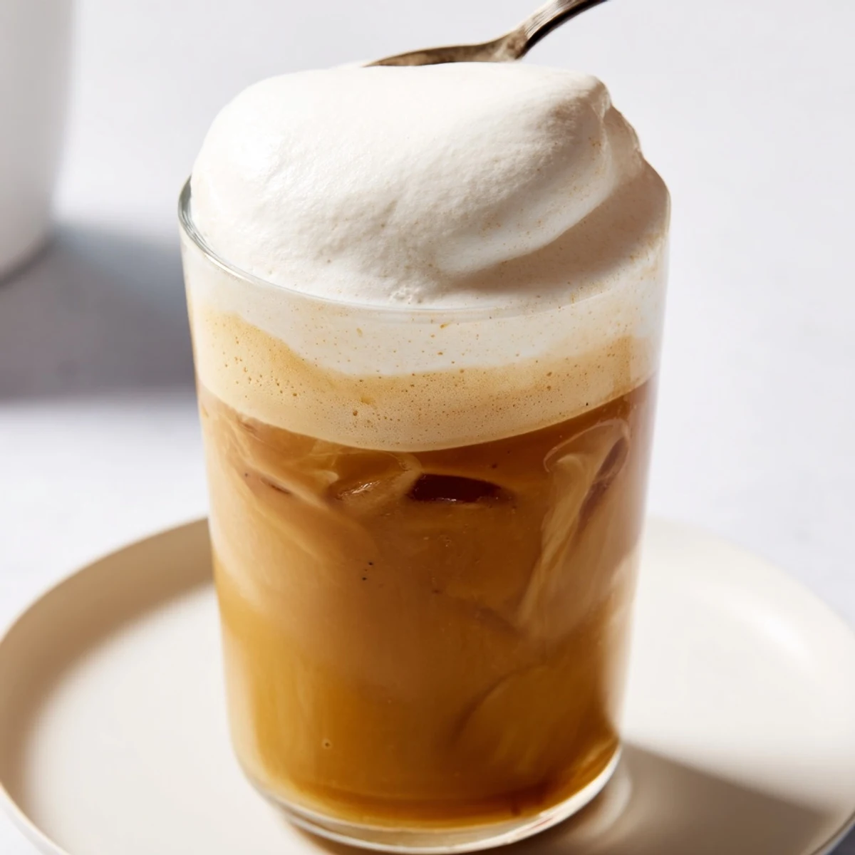 Creamy vanilla-infused Starbucks Cold Foam, a perfect topping for iced beverages, ready to be enjoyed.