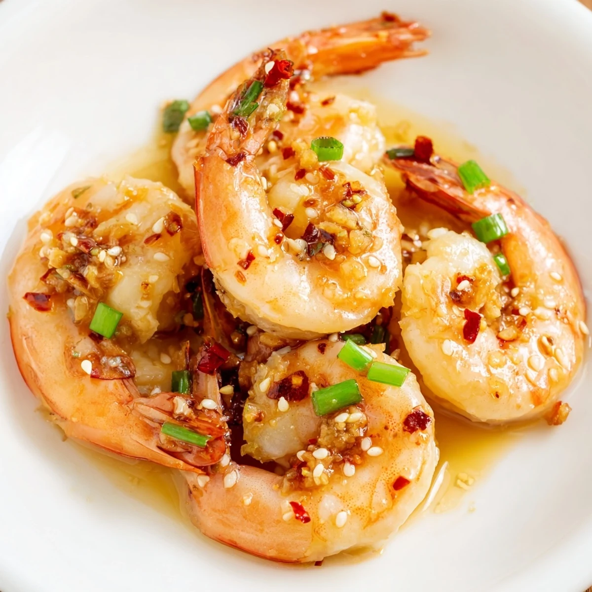 A close-up of delicious Korean garlic butter shrimp, ready to serve with a squeeze of lemon.