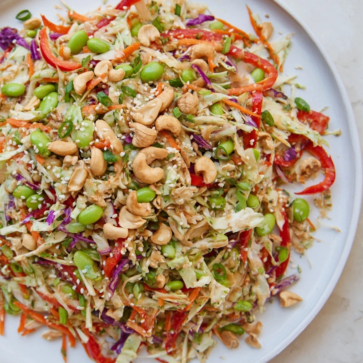 A colorful bowl of Edamame Crunch Chicken Salad with a zesty ginger dressing, ready to eat.