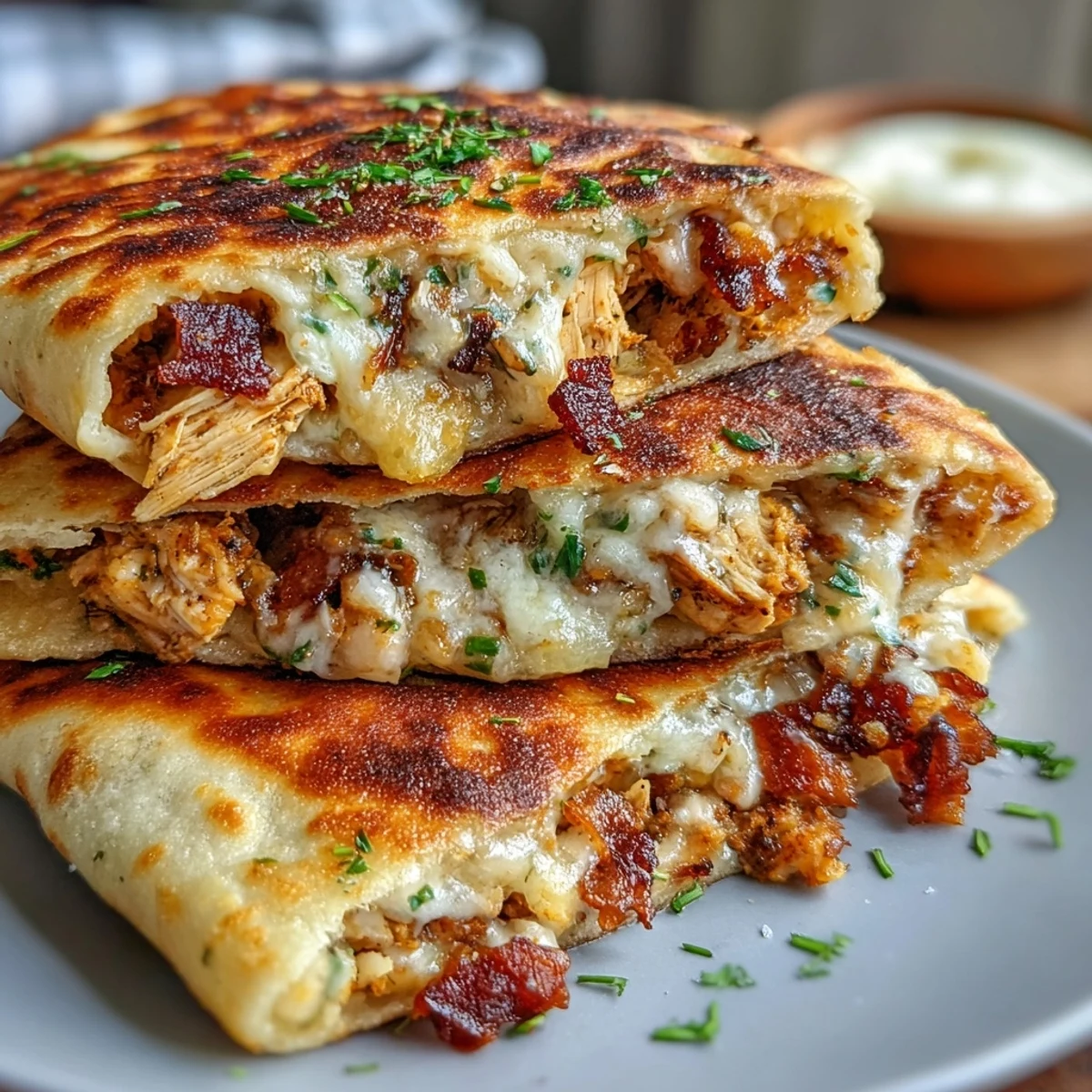 Fork cutting into a warm half-moon garlic naan filled with shredded ranch chicken