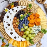 Delicious Crescent Moon Midnight Snack Board featuring brie, cheddar, and fruit, ready for a starry night.
