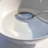 Refreshing glass of infused water with vibrant fruit slices and mint leaves.  