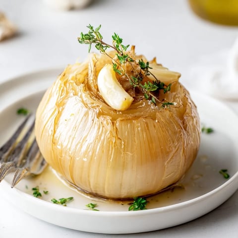 Roasted whole onion boil, tender and sweet, bubbling with butter and herbs, a perfect side.