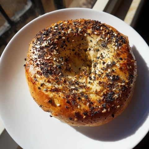 Golden brown Homemade Budget Bagels, fresh from the oven, offering a satisfying, chewy texture for breakfast.
