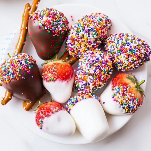Colorful and fun Rainbow Sprinkle Party Board with chocolate-dipped treats ready to be enjoyed.
