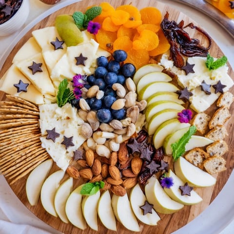 Crescent Moon Midnight Snack Board: A beautiful, detailed appetizer board with cheeses, fruits, and crackers awaiting enjoyment.