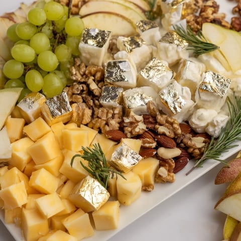 Golden aged Gouda and cheddar cheese cubes on a festive Gold and Silver Cheese Cube Board, ready to serve.