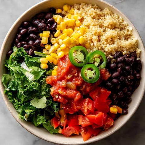 A bowl of food with tomatoes, corn, beans, and peppers.