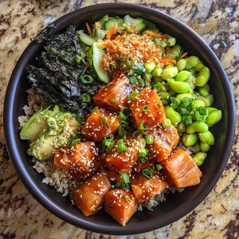 A bowl of food with rice, vegetables, and meat.