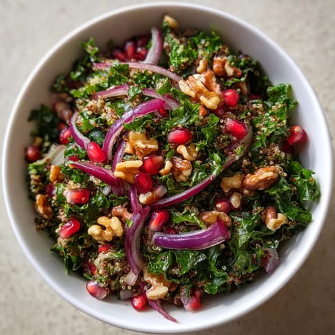A bowl of salad with onions, nuts and pineapple.