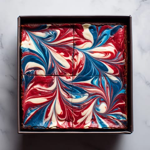 A slice of cake with blue and red swirls.