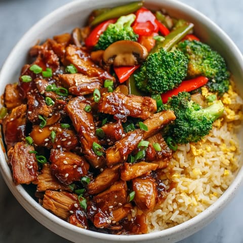 A bowl of food with meat, broccoli, and peppers.