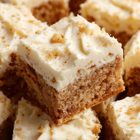 A slice of cake with white frosting.