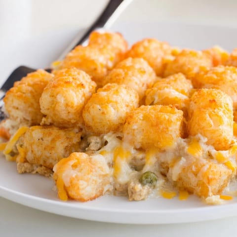 Baked Sweet Potato Tater Tot Casserole: ground turkey, vibrant veggies, bubbling cheddar cheese.