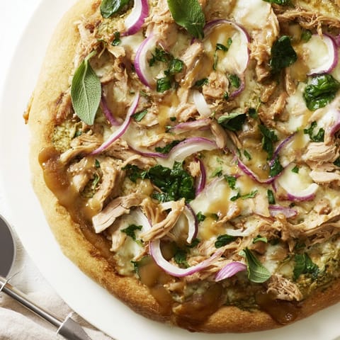 Hearty Sage Turkey Gravy Pizza baking, showing bubbly cheese and golden-brown crust details.