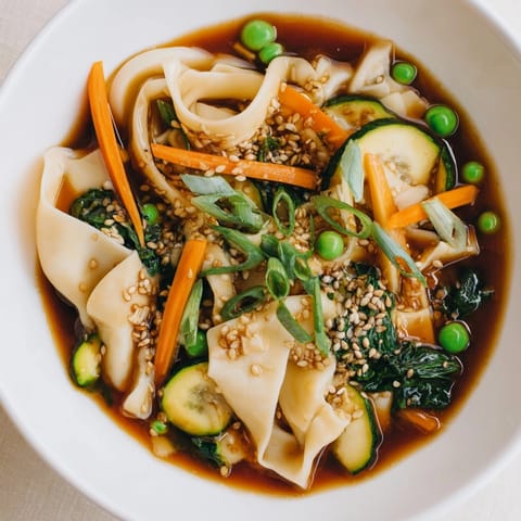 A steaming bowl of Sweet Soy Udon Lasagne Soup, cheese melting, garnished with scallions.