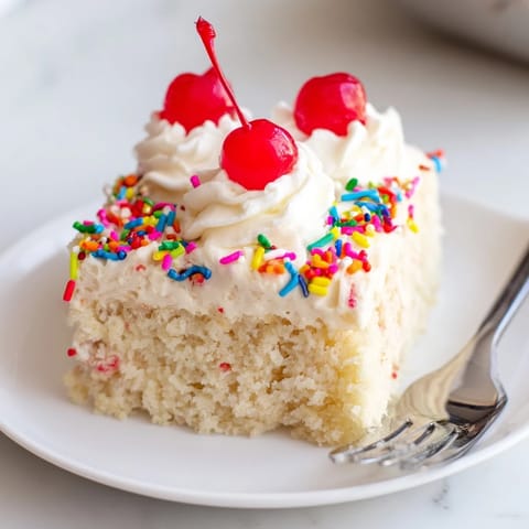 Delicious Classic Soda Float Sheet Cake served with whipped cream and cherries.  