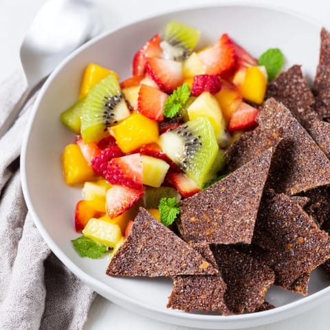 Delightful dessert chips & salsa featuring sweet cocoa tortillas and vibrant fruit mix.  
