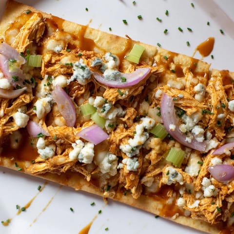 Golden-brown buffalo chicken & blue cheese flatbread, drizzled with creamy dressing for extra flavor.  